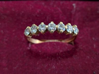 a close up of a gold ring with diamonds on it