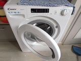 a washing machine that is sitting in the corner of the room