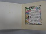an open book with a picture of flowers on it