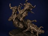 a bronze statue of a man on a horse with two bulls