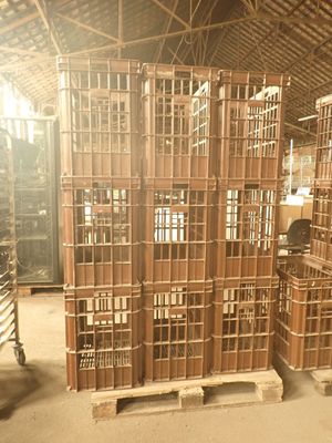 many wooden crates stacked on pallets in a warehouse