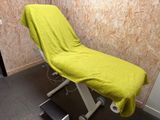 a yellow blanket on a white table in a room