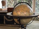a table with a globe on it in front of a window