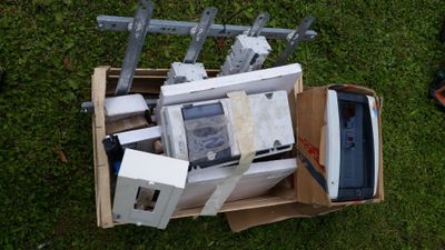 a box full of electronic equipment on the grass