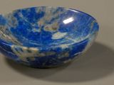 a blue and white marble bowl sitting on a table