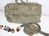 a duffel bag and some pins on a table
