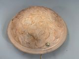 an image of a clock with a carved face on it