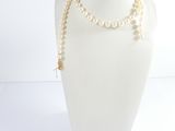 pearl necklace on mannequin display with white background