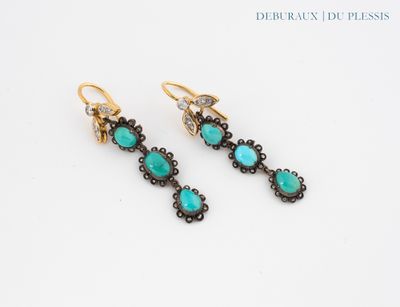 a pair of earrings with turquoise stones and diamonds