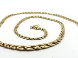 a close up of a gold chain on a white background