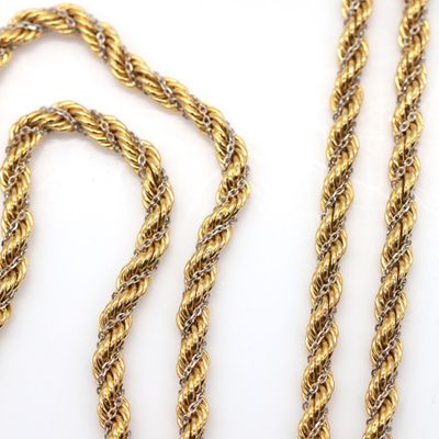 two pieces of gold rope on a white surface