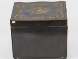 an old black box with a decorative design on the lid