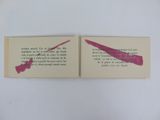 two pages of a book with a pink ink stain on them