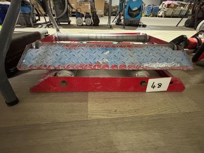 a picture of a red and silver skateboard sitting on a wooden floor