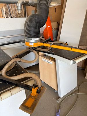 une photo d'une machine en train de scier un morceau de bois