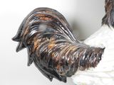 a statue of a rooster that is standing on a table