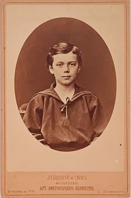 an old photo of a young boy in a sailor ' s outfit