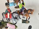 many figurines of soldiers on display in a glass case