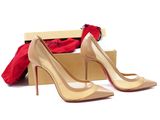 pair of women ' s nude colored high heeled shoes in a box