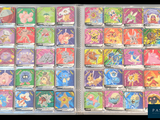 many different pokemon cards in a clear box