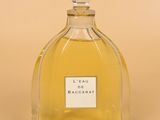 an image of a bottle of perfume sitting on top of a table