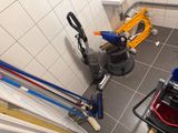 a view of a bathroom with a toilet and a cleaning machine