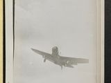 an old photo of a small airplane flying in the sky