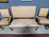 three chairs and a couch in a room with a rug