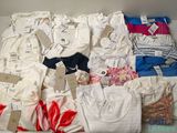 a lot of clothes that are sitting on a table