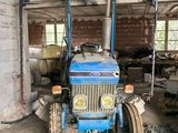 a blue tractor that is parked in a garage