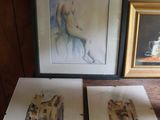 two framed pictures of a woman sitting on a table next to a picture of a man