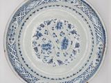 blue and white plate with floral design on it on a white surface