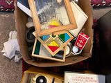 a box full of books and a camera on the floor