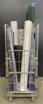 many rolls of wrapping sitting in a wire basket