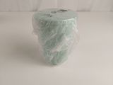 a roll of toilet paper wrapped in plastic on a white surface