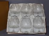 six wine glasses in a box on a table