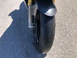 a close up of a motorcycle parked on the side of the road