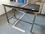 a table that has a piece of metal on top of it