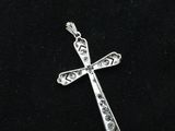 a silver cross on a black background