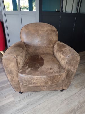 a brown chair that is sitting on a hard wood floor