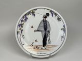 a plate with a picture of a man holding a tennis racquet