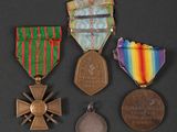 three medals and a medal on a black surface