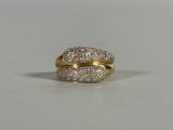 an image of a gold and diamond ring on a white surface