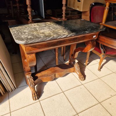 a table with a marble top on it in a room