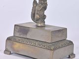 a statue of a squirrel on top of a box