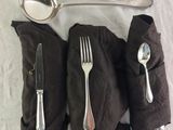two spoons, a fork, and a spoon on a table