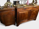 two wooden cabinets with a clock on top of them