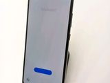 the back of a black samsung note9 with a blue button on it