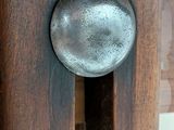 a close up of a wooden door with a metal knob