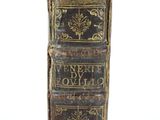 an old book with writing on it sitting on top of a table